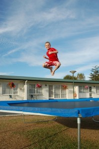 A.J. flying high on a trampoline at a typical motel in New Zealand