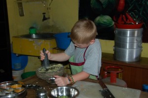 A.J. takes his turn with the mortar and pestle